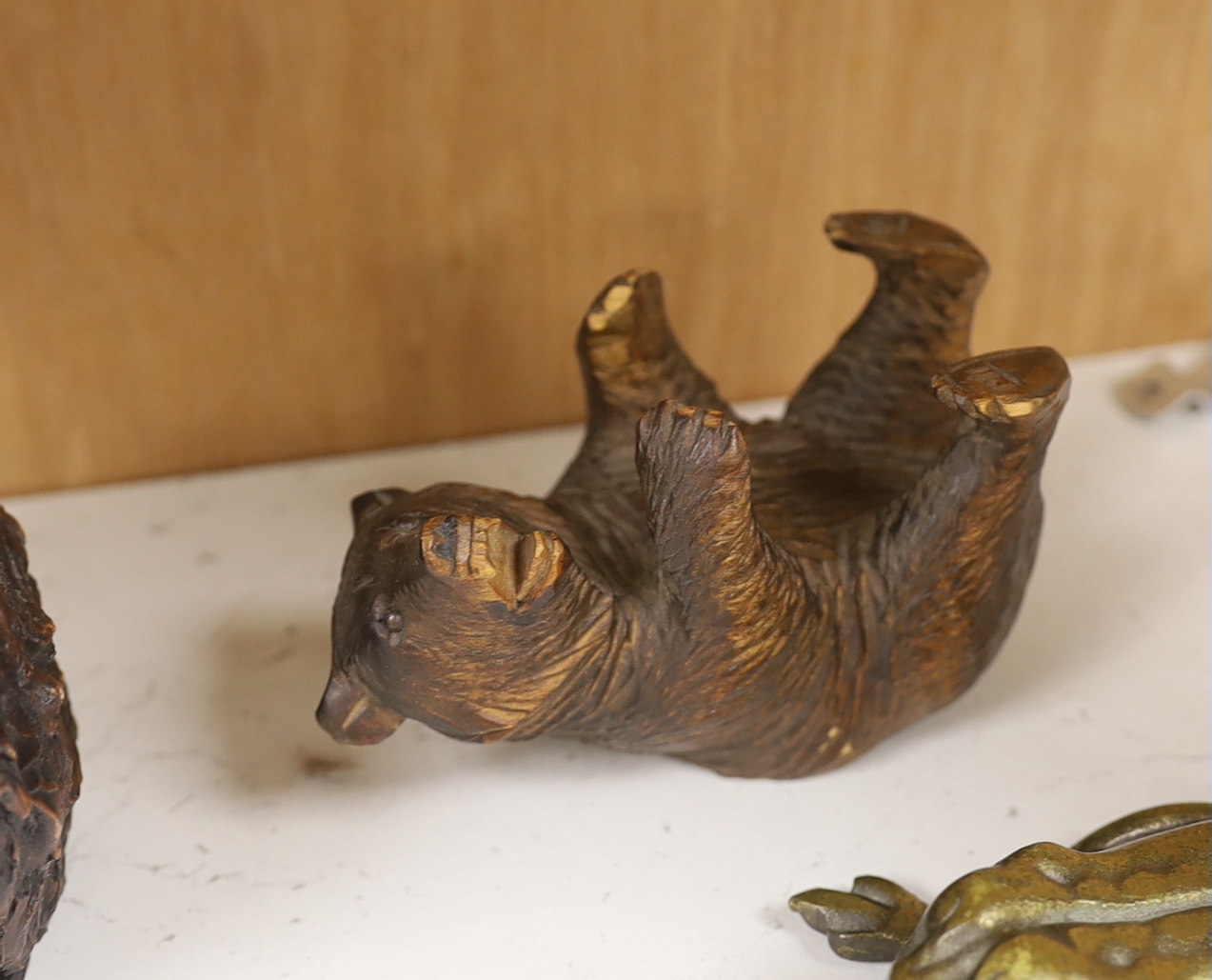 A resin Black Forest bear sculpture, a smaller Black Forest bear (possibly an ink stand but missing glass insert) together with a glass pen dish and brass hinged frog, the largest 25cm high